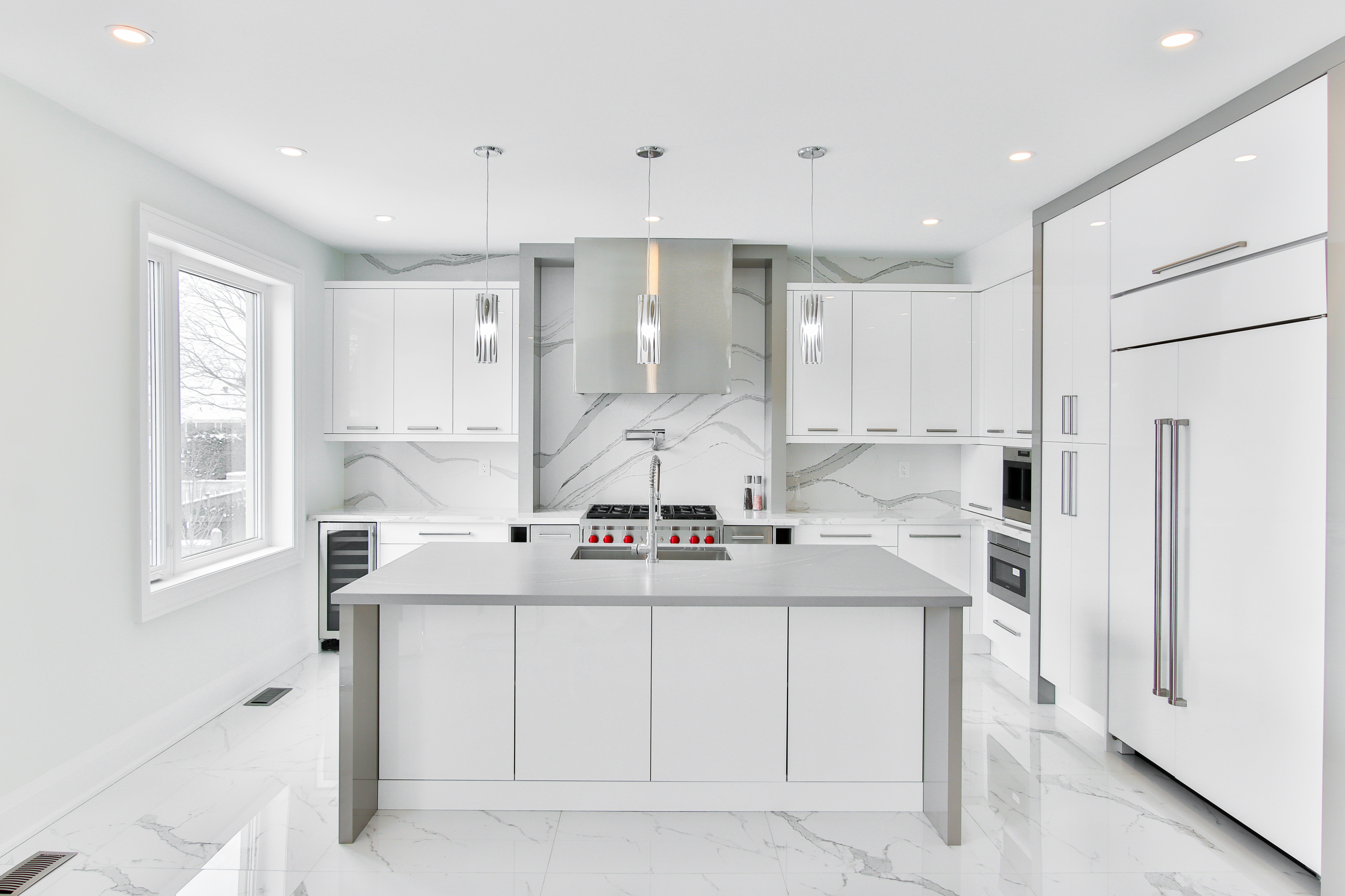 Bright modern kitchen with marble and stainless after a clean
